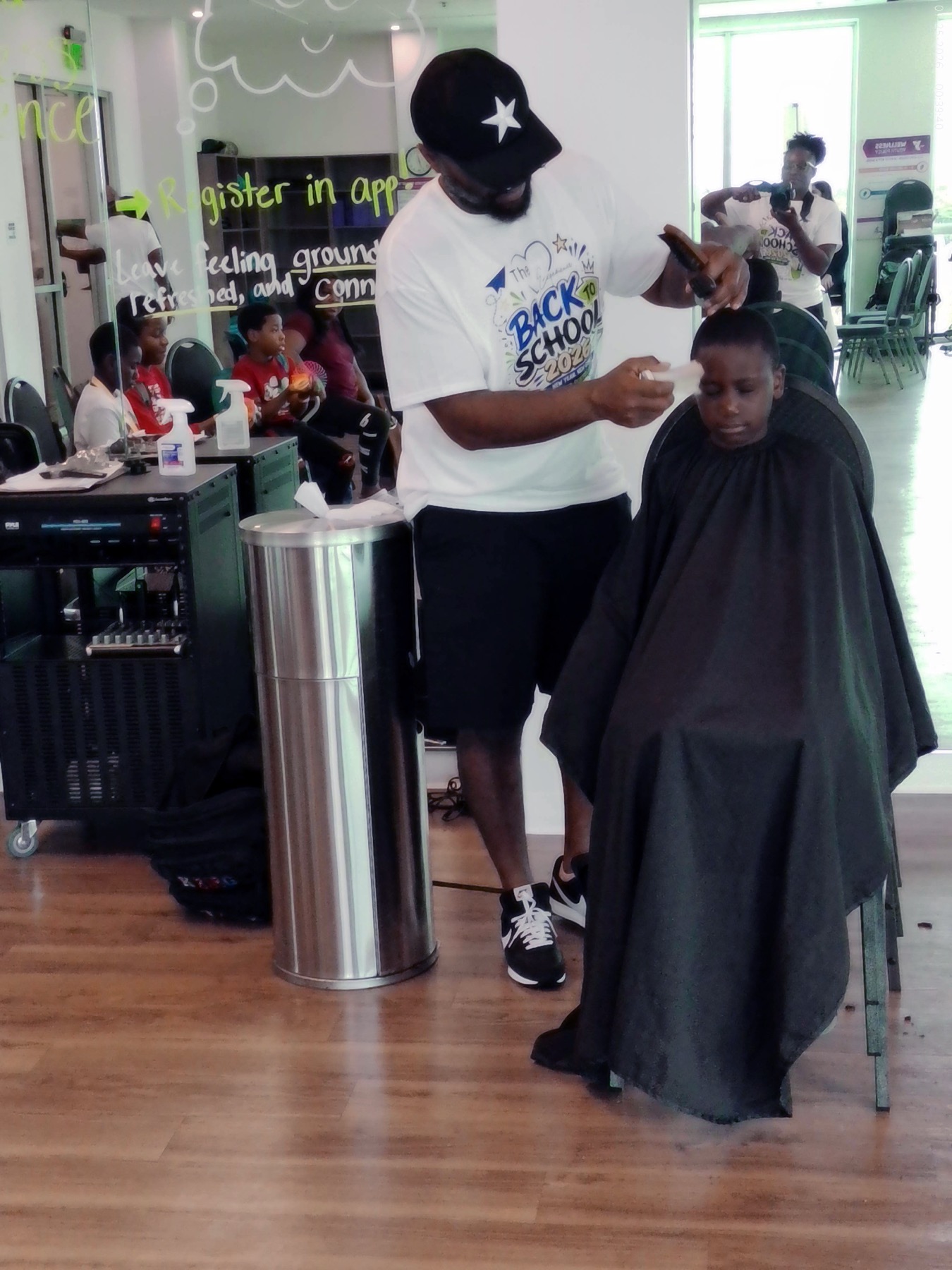 A child receiving a haircut at an Experience Foundation back-to-school event