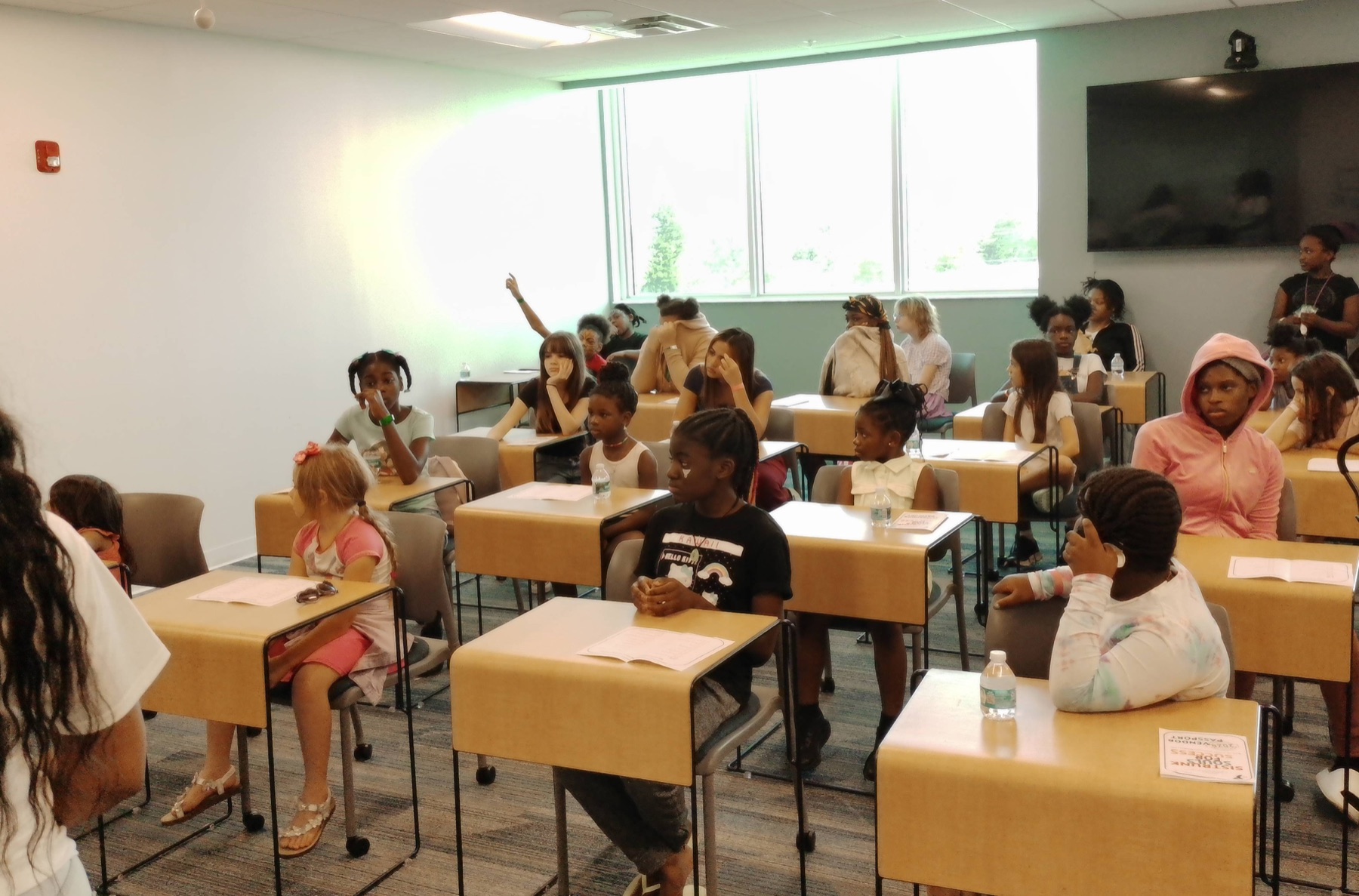 Children gathered in a classroom during a community learning experience